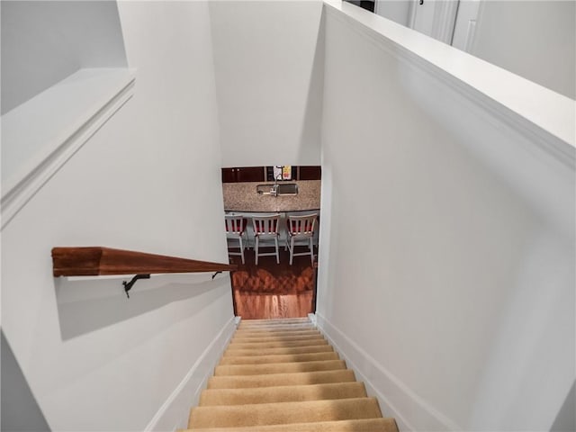 stairway with hardwood / wood-style flooring