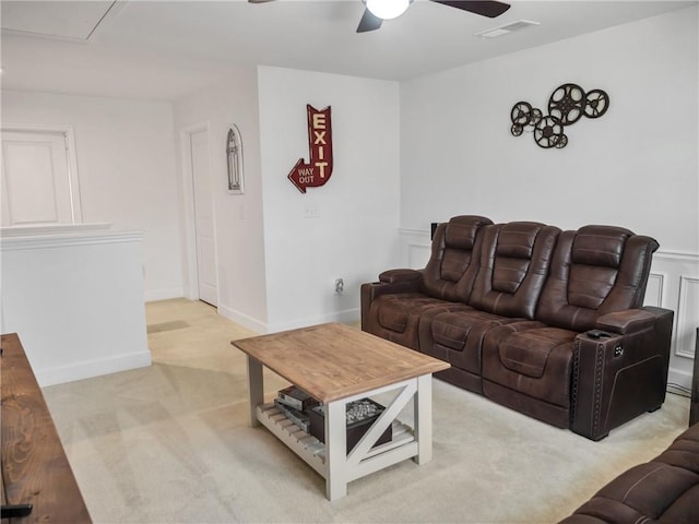 living room featuring light carpet and ceiling fan