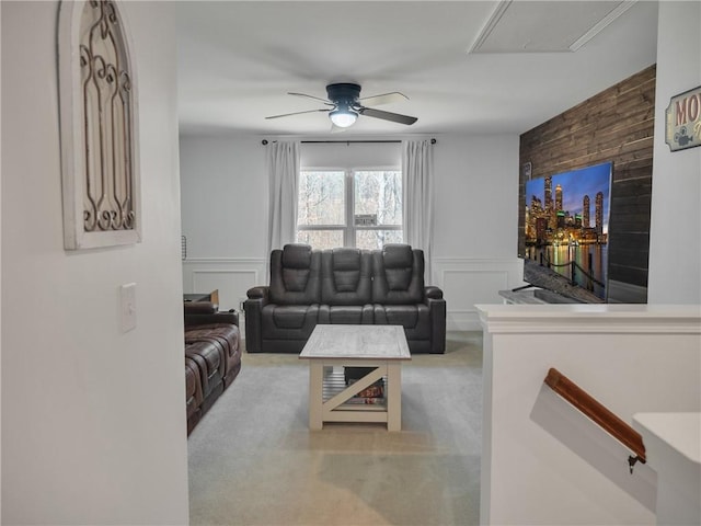 carpeted living room with ceiling fan