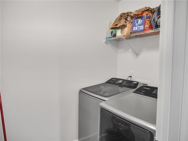 clothes washing area with washing machine and dryer