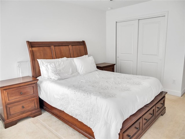 bedroom with light carpet and a closet