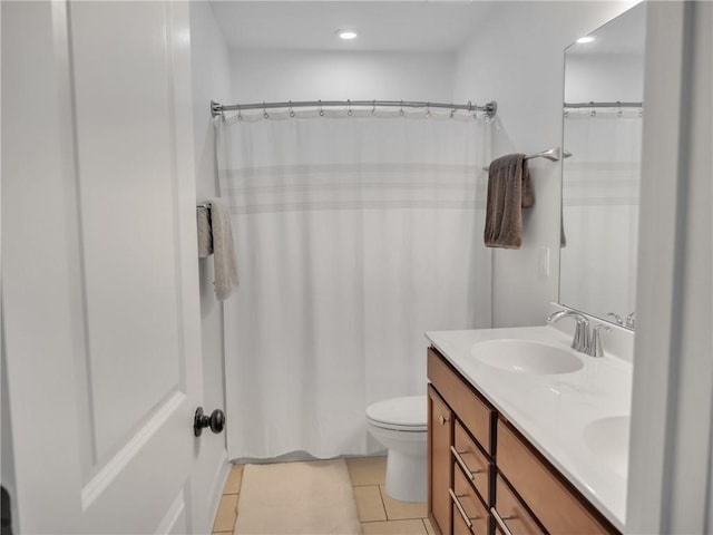 bathroom with vanity, toilet, curtained shower, and tile patterned flooring