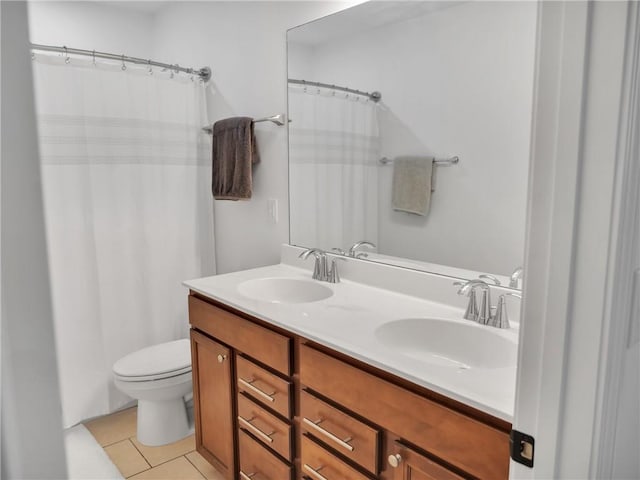 bathroom with vanity, tile patterned floors, and toilet