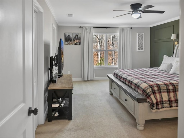 carpeted bedroom featuring crown molding and ceiling fan