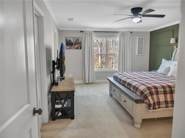 bedroom with crown molding, light colored carpet, and ceiling fan