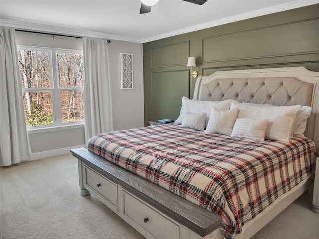 bedroom with crown molding, light colored carpet, and ceiling fan