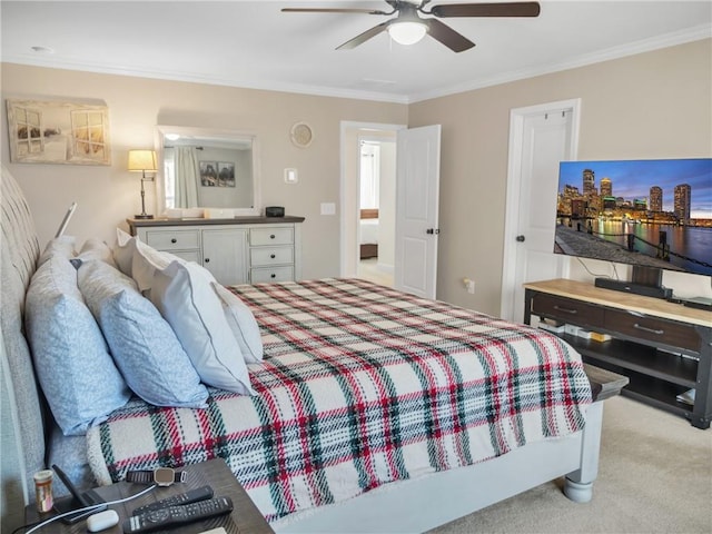 carpeted bedroom with crown molding and ceiling fan