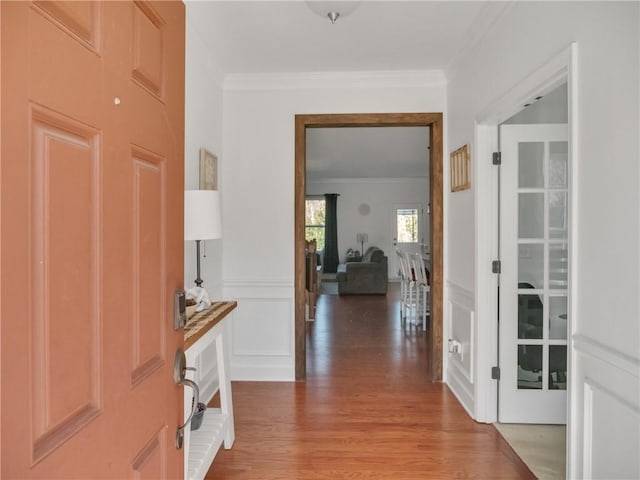 foyer with hardwood / wood-style flooring and crown molding