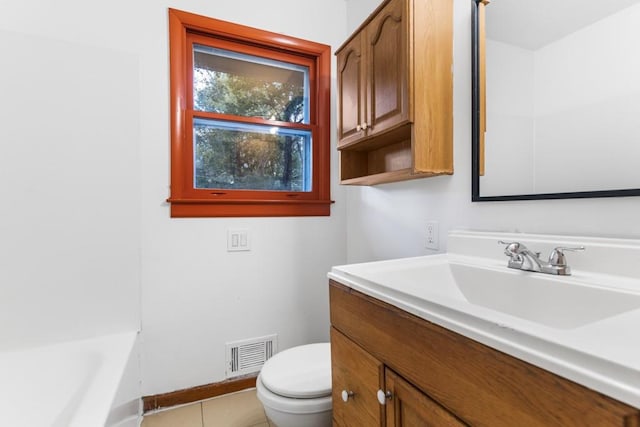 bathroom featuring a tub, tile patterned flooring, vanity, and toilet