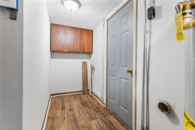 washroom featuring a textured ceiling and dark wood-type flooring