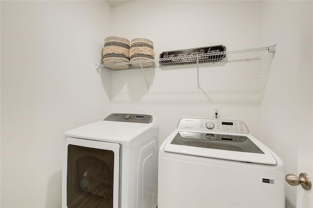 laundry room featuring washer and clothes dryer