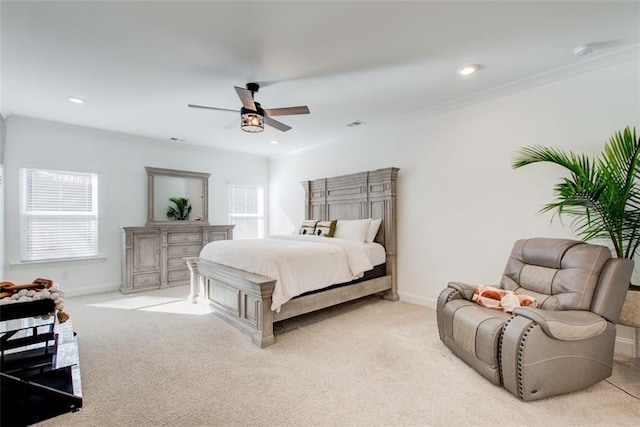 carpeted bedroom featuring ceiling fan and ornamental molding