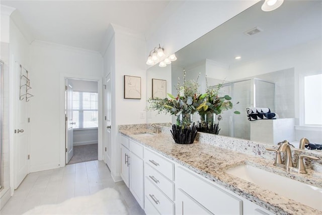 bathroom featuring ornamental molding, a shower with shower door, tile patterned floors, and vanity