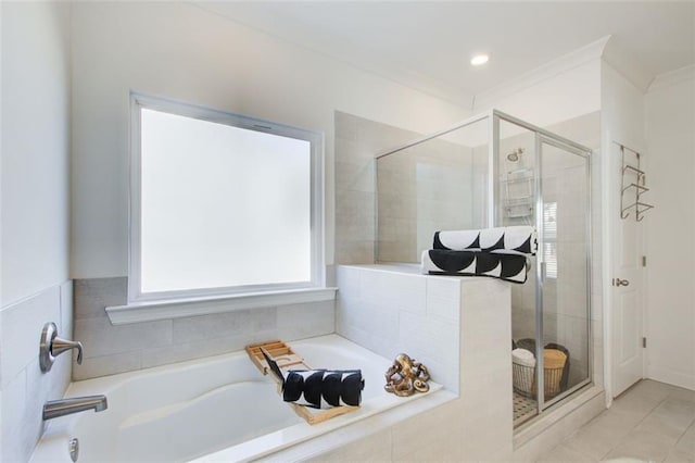 bathroom with crown molding and independent shower and bath