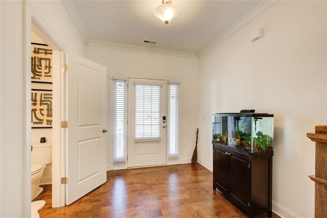 foyer with wood-type flooring and ornamental molding