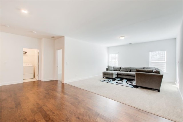 living room featuring wood-type flooring and washer / clothes dryer