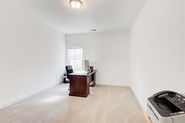 office area featuring light colored carpet