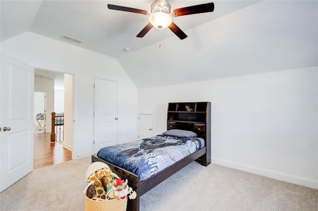 bedroom featuring ceiling fan, light carpet, and vaulted ceiling