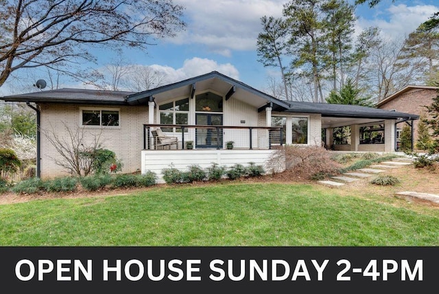 mid-century home featuring brick siding and a front yard