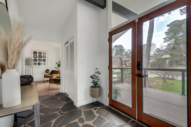 entryway with french doors, vaulted ceiling, and baseboards