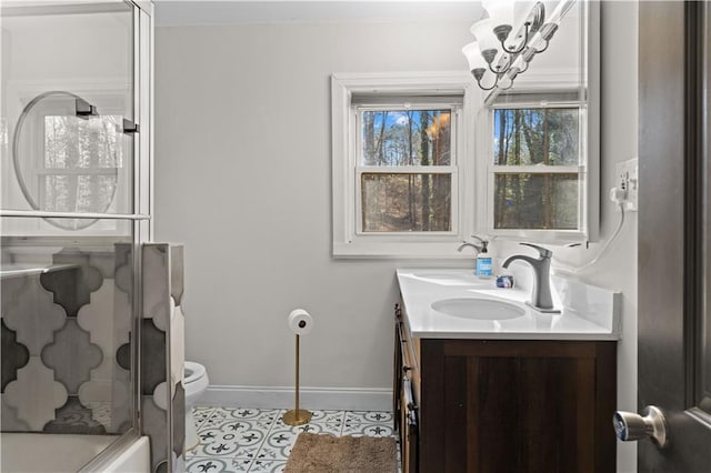 full bathroom featuring double vanity, an enclosed shower, a sink, tile patterned flooring, and baseboards