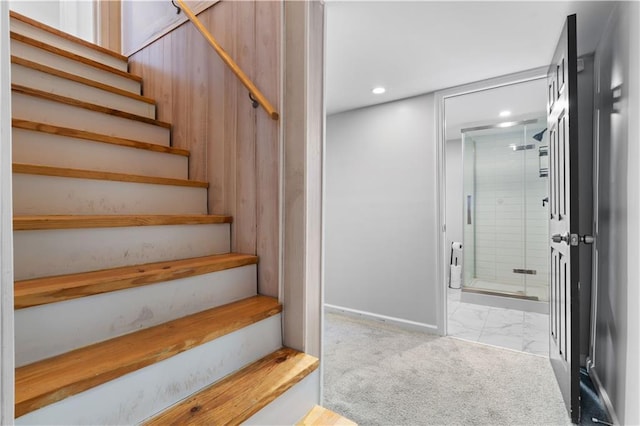 staircase with recessed lighting, marble finish floor, and carpet flooring