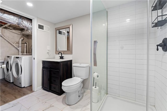 bathroom with marble finish floor, washer and clothes dryer, visible vents, toilet, and a stall shower