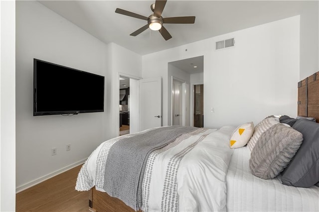 bedroom with hardwood / wood-style flooring and ceiling fan