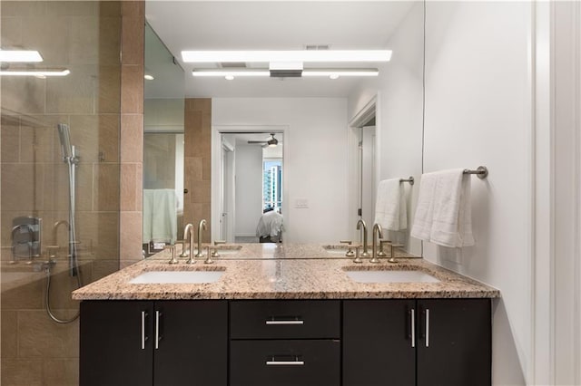 bathroom with an enclosed shower, vanity, and ceiling fan