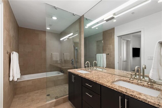 3325 Piedmont Rd NE Unit 2407, Atlanta, GA 30305 - full bath featuring a sink, tile walls, and a relaxing tiled tub