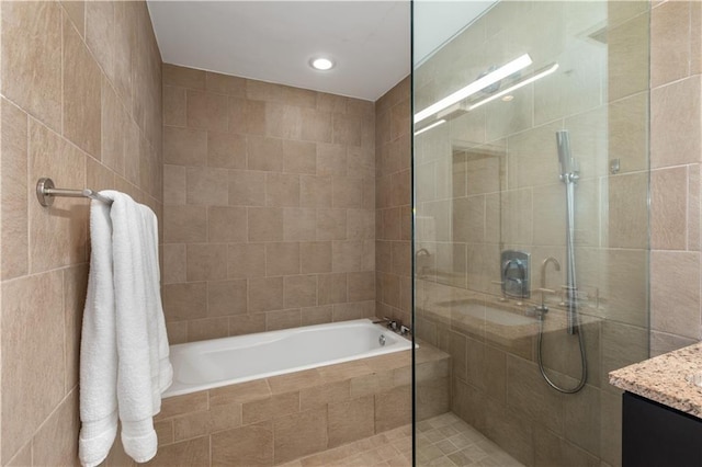 3325 Piedmont Rd NE Unit 2407, Atlanta, GA 30305 - bathroom with a relaxing tiled tub, recessed lighting, vanity, and tiled shower