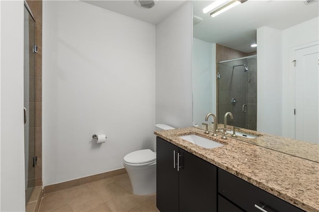 bathroom with tile patterned flooring, walk in shower, vanity, and toilet