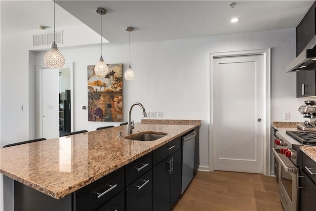 3325 Piedmont Rd NE Unit 2407, Atlanta, GA 30305 - kitchen featuring visible vents, a peninsula, a sink, light wood-style flooring, and appliances with stainless steel finishes