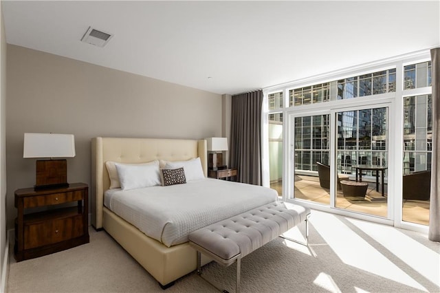 3325 Piedmont Rd NE Unit 2407, Atlanta, GA 30305 - carpeted bedroom featuring visible vents, access to exterior, and expansive windows