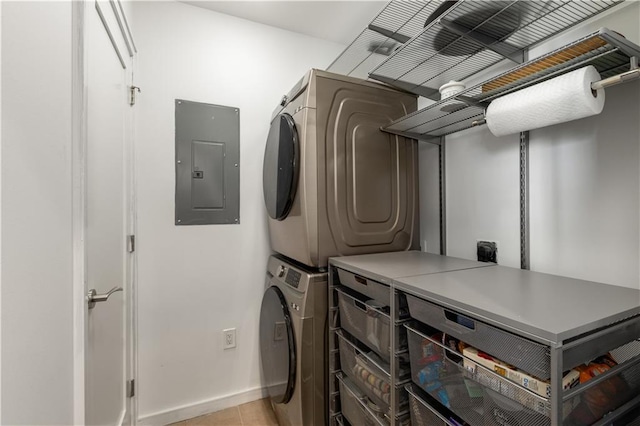 laundry room with stacked washer and dryer, light tile patterned floors, and electric panel