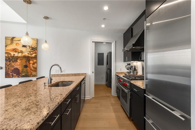 3325 Piedmont Rd NE Unit 2407, Atlanta, GA 30305 - kitchen featuring high quality appliances, light wood-type flooring, a sink, dark cabinetry, and wall chimney exhaust hood