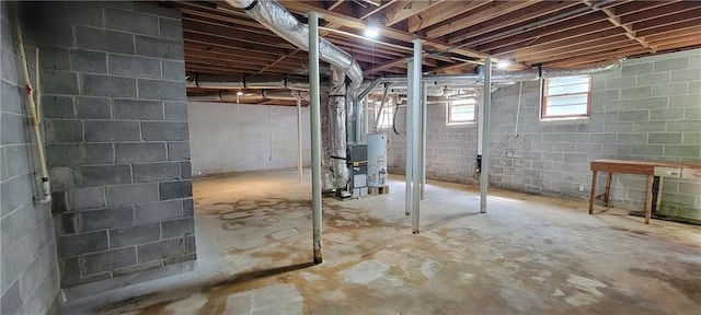 below grade area featuring heating unit and gas water heater