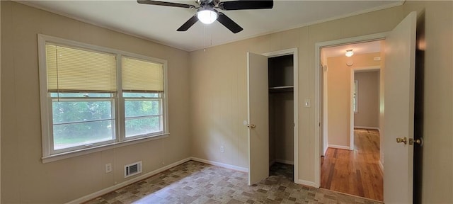 unfurnished bedroom with crown molding, a ceiling fan, baseboards, and visible vents