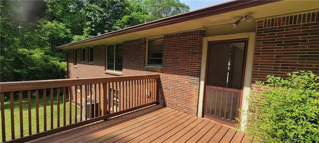 wooden terrace with a lawn
