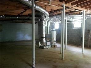 basement with water heater and heating unit