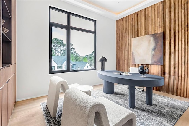 office space with wooden walls, baseboards, and wood finished floors