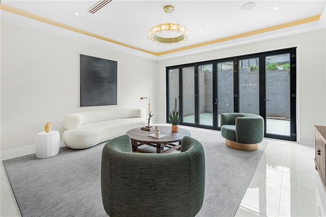 living area featuring visible vents, baseboards, and a raised ceiling