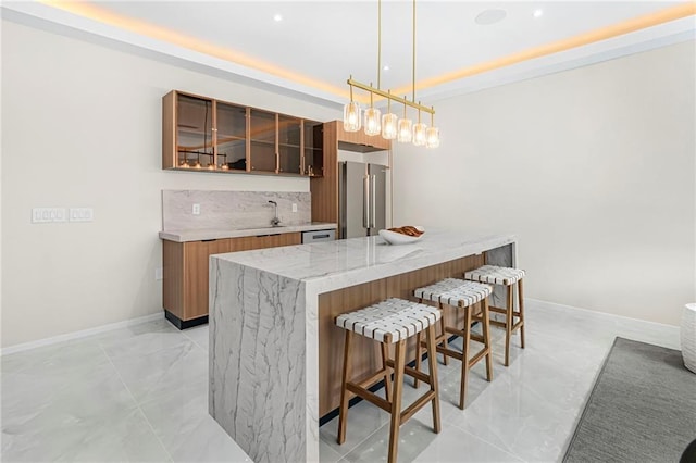 bar with baseboards, decorative light fixtures, indoor wet bar, a sink, and high quality fridge