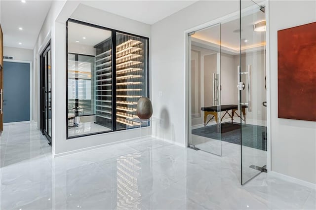 wine cellar featuring visible vents, baseboards, recessed lighting, and marble finish floor