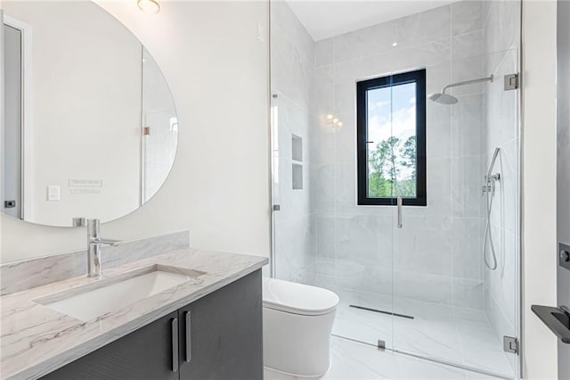 full bath with a shower stall, vanity, marble finish floor, and toilet