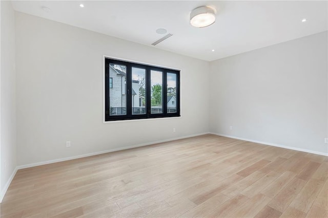 spare room featuring visible vents, baseboards, light wood-type flooring, and recessed lighting
