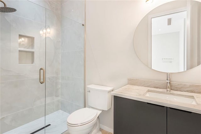 full bathroom with toilet, vanity, and a shower stall