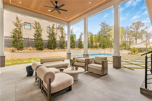 view of patio with a fenced in pool, fence, and a ceiling fan