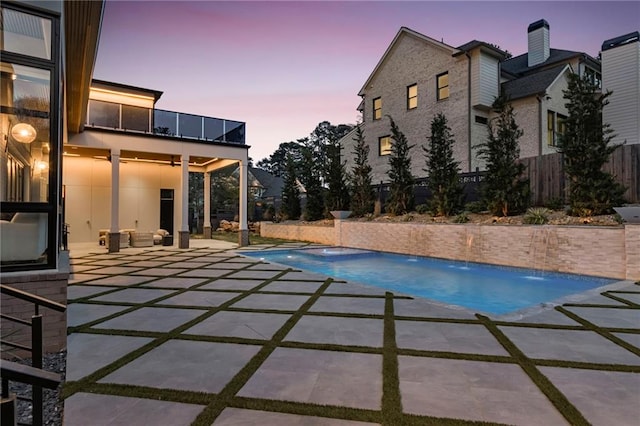 view of swimming pool featuring a patio area, a fenced in pool, and fence