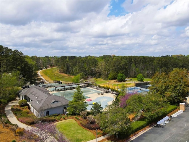 bird's eye view with a wooded view
